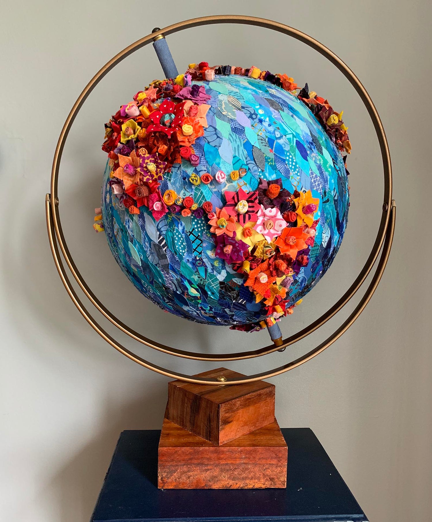An art piece depicting a globe covered in flowers