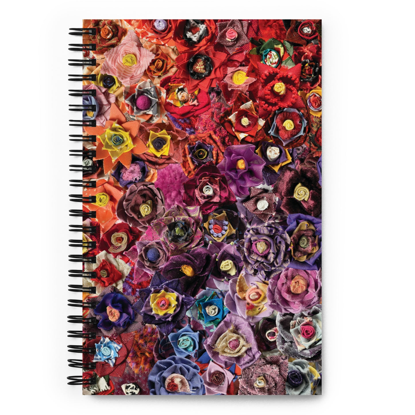 Spiral bound notebook with a pink and purple image of fabric flowers