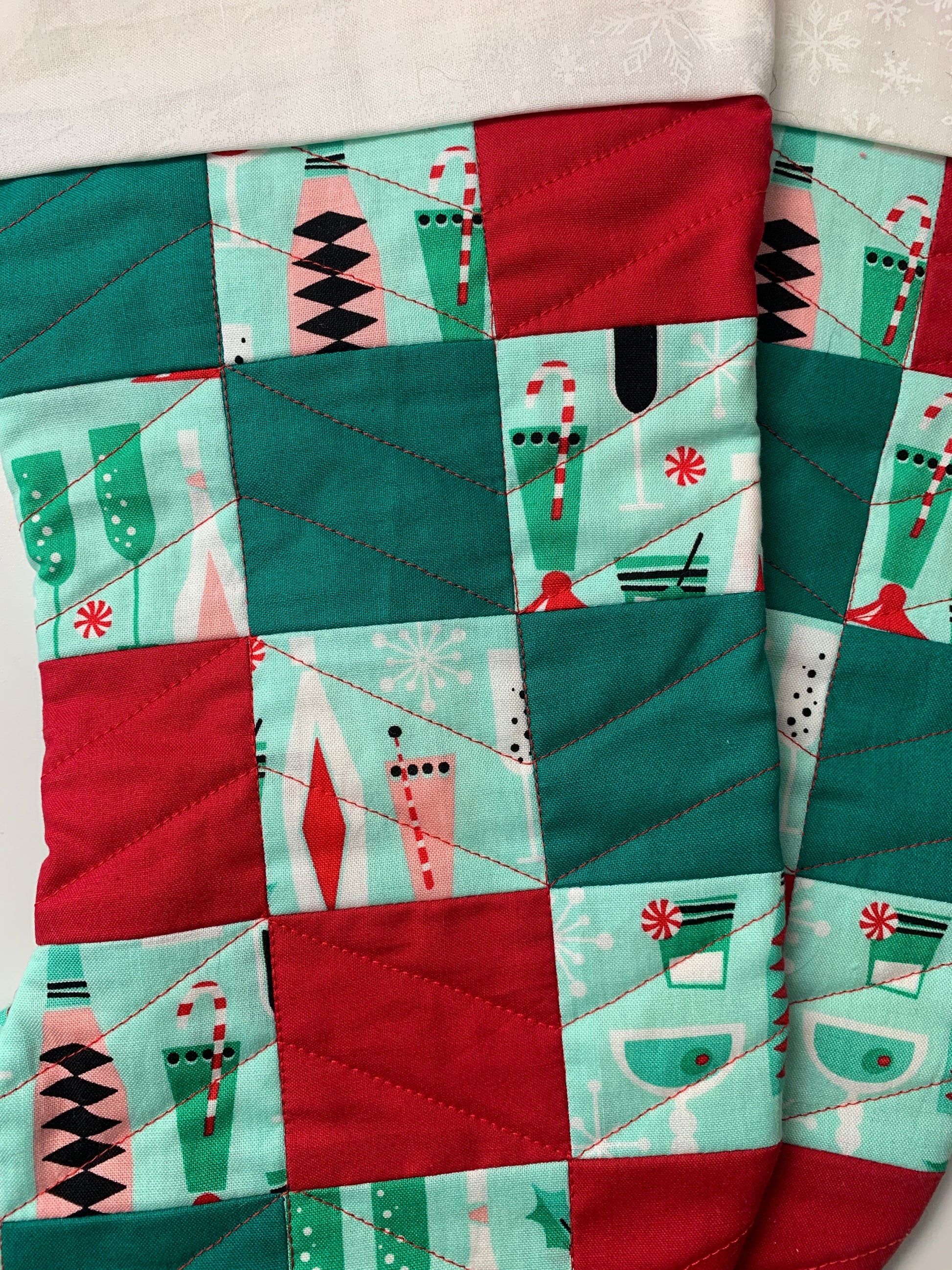 Close up image of Christmas stockings with alternating red and green patchwork