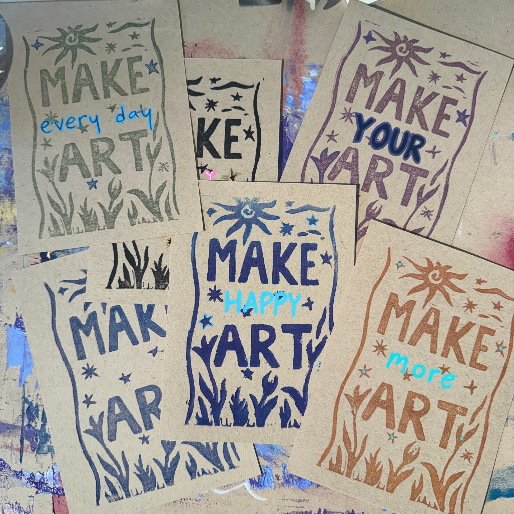 Multiple tan cards with text reading "Make Art" in different colors