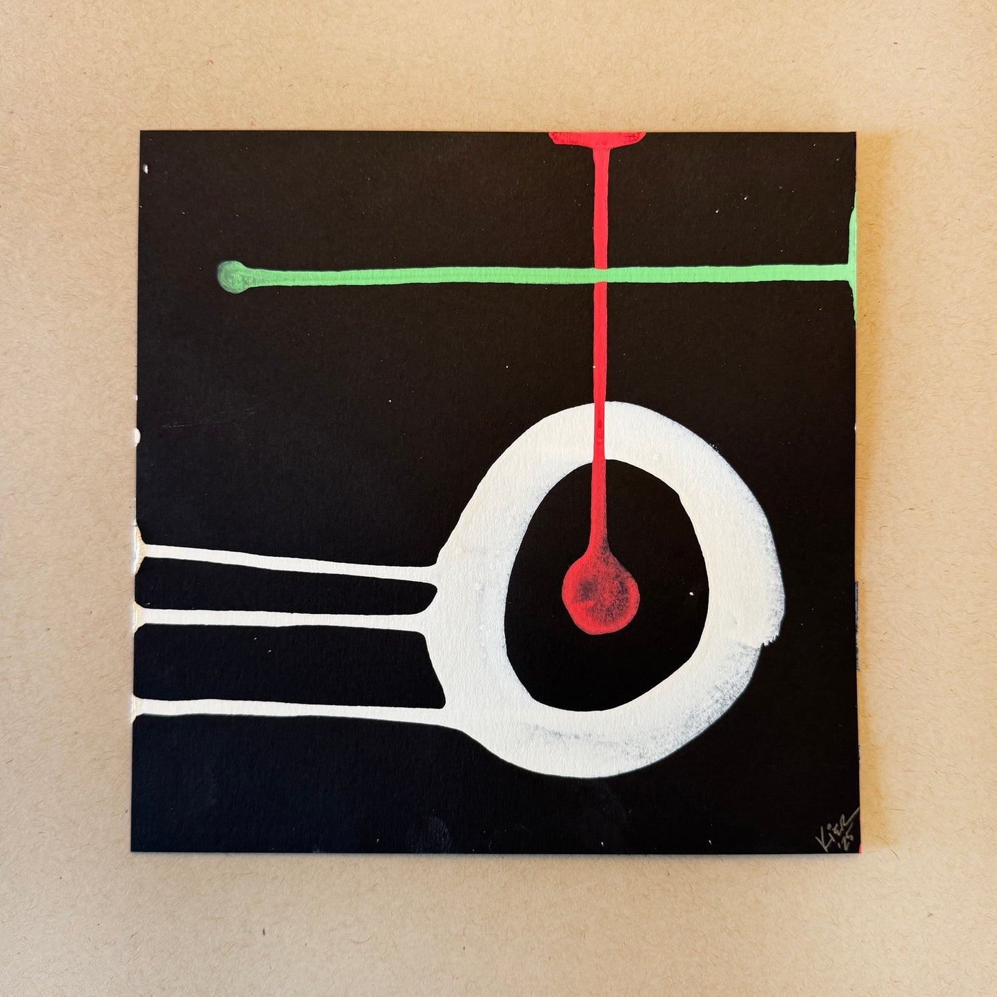 Abstract art piece with a black square, white circle, red droplet, and green line on a beige background.