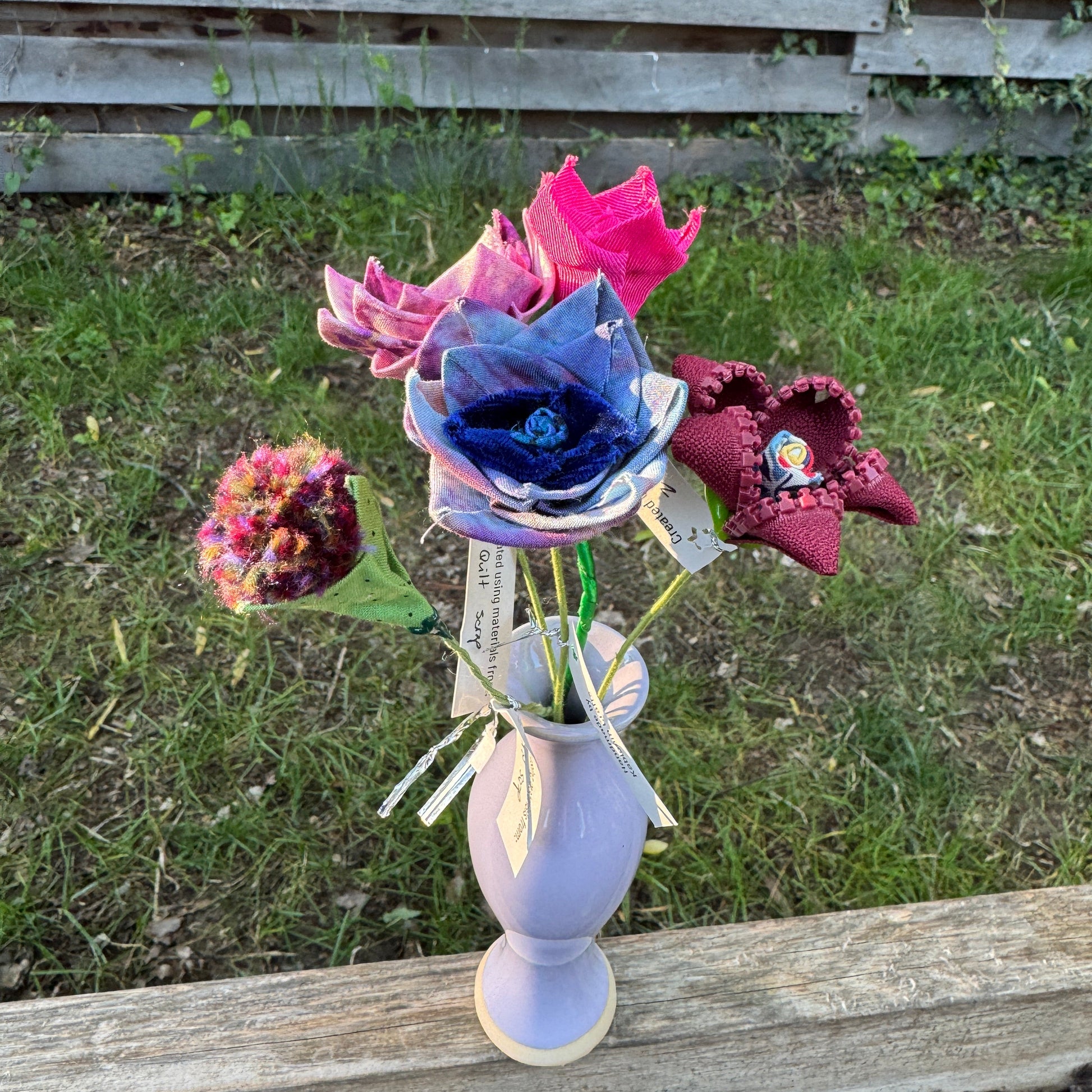 Colorful fabric flowers arranged in vase