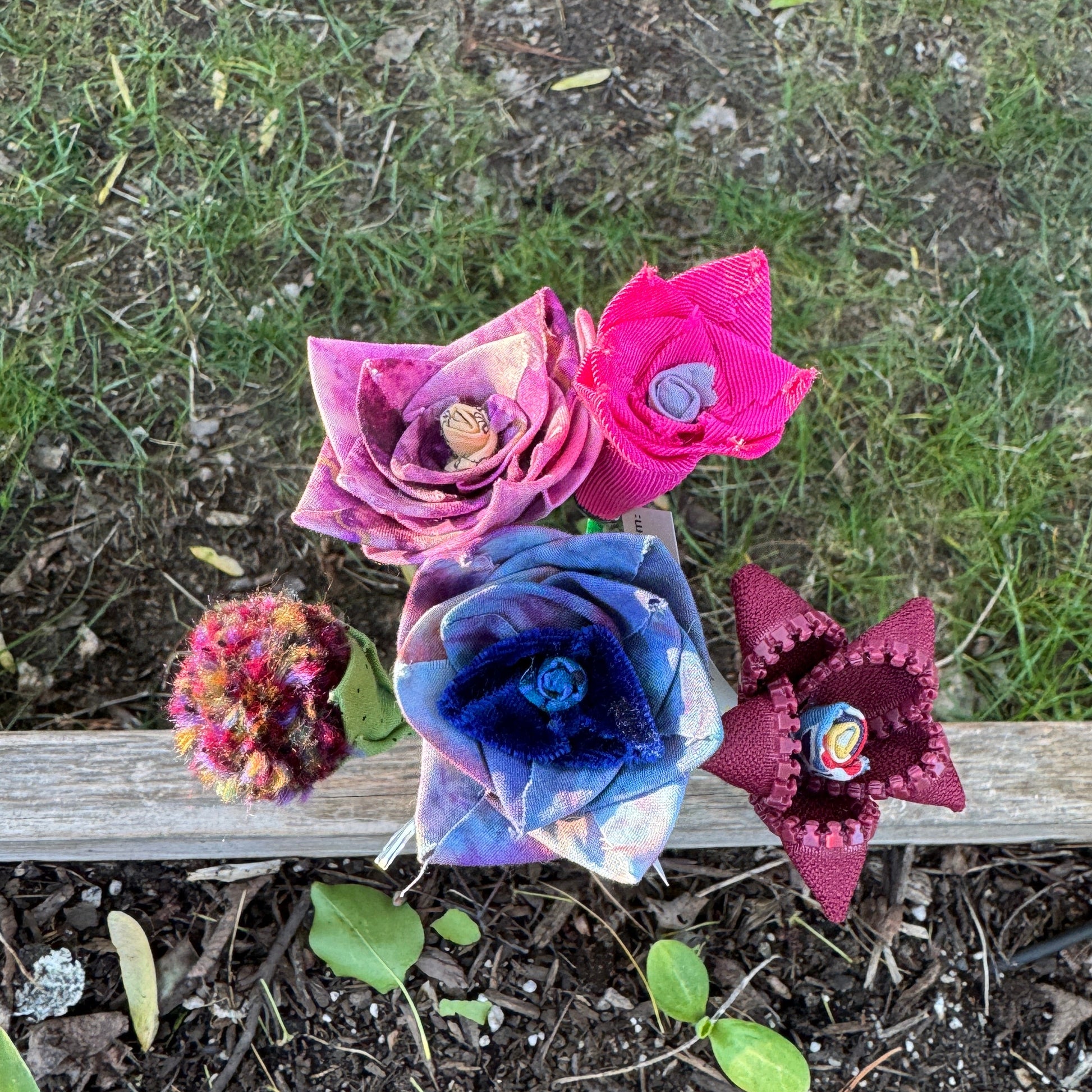 Colorful fabric flowers arranged in vase