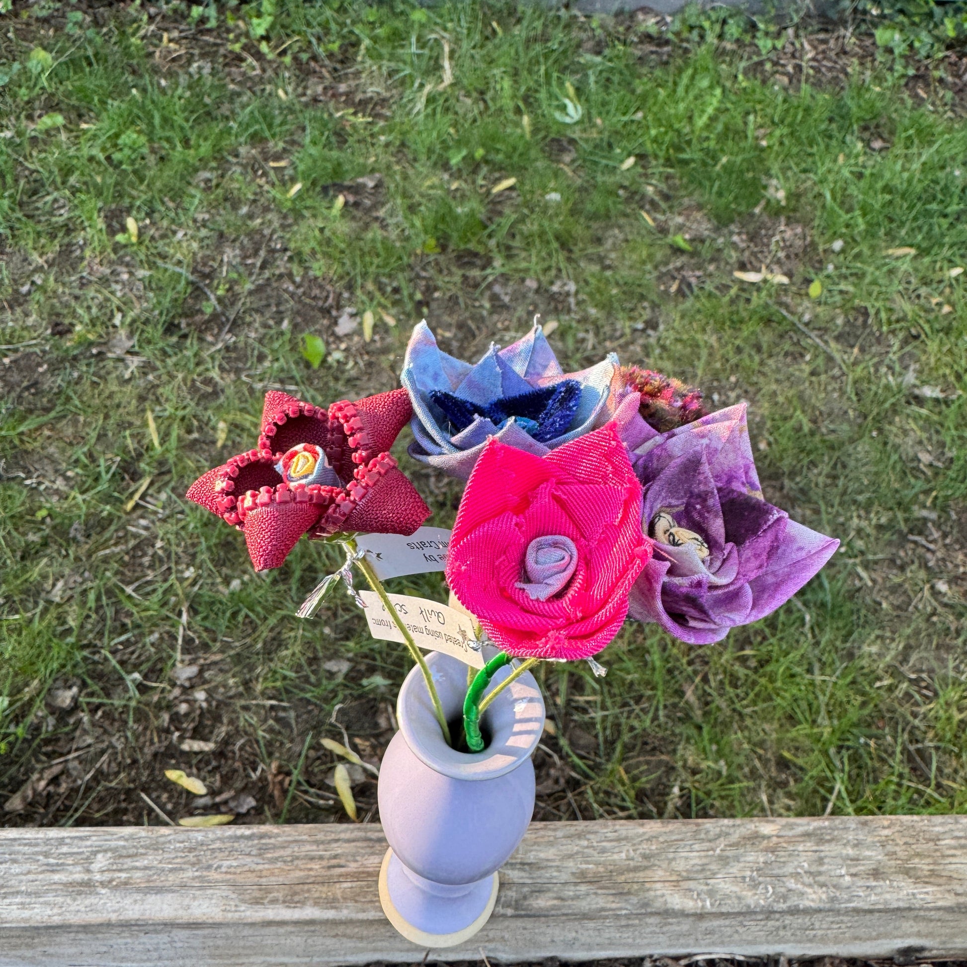 Colorful fabric flowers arranged in vase
