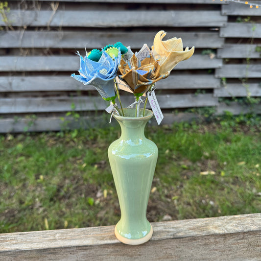 Colorful fabric flowers arranged in vase