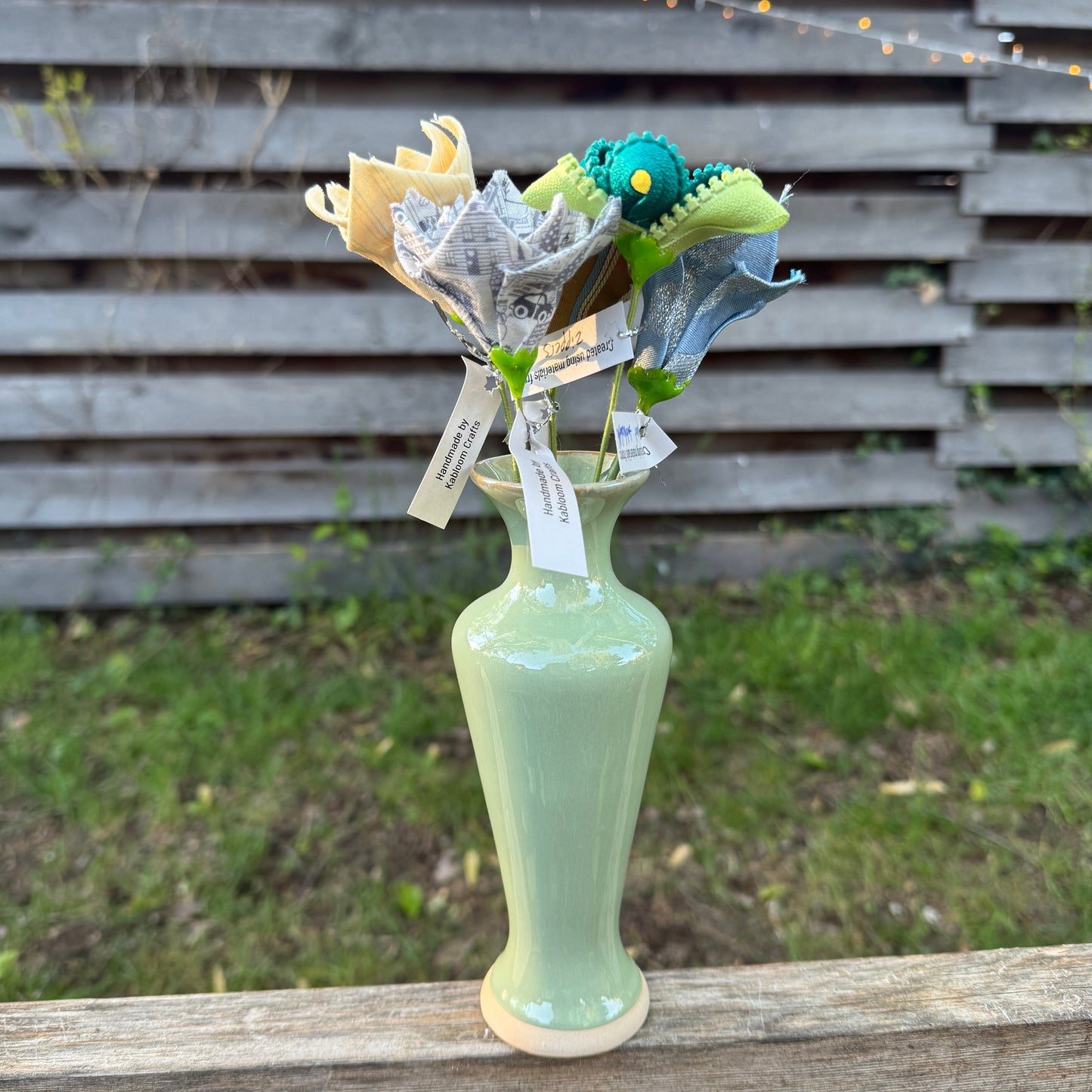Colorful fabric flowers arranged in vase