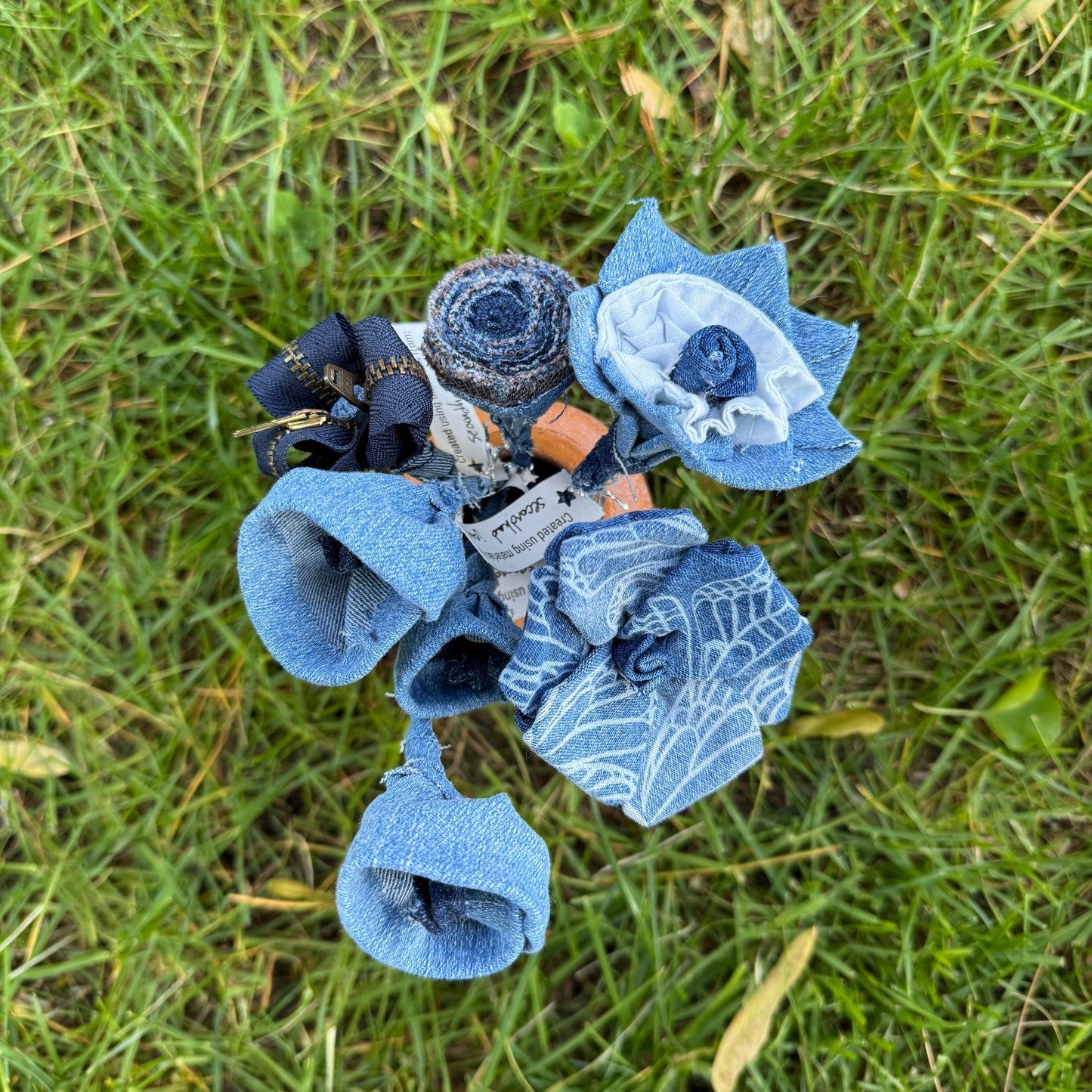 Bouquet of blue fabric flowers on grass