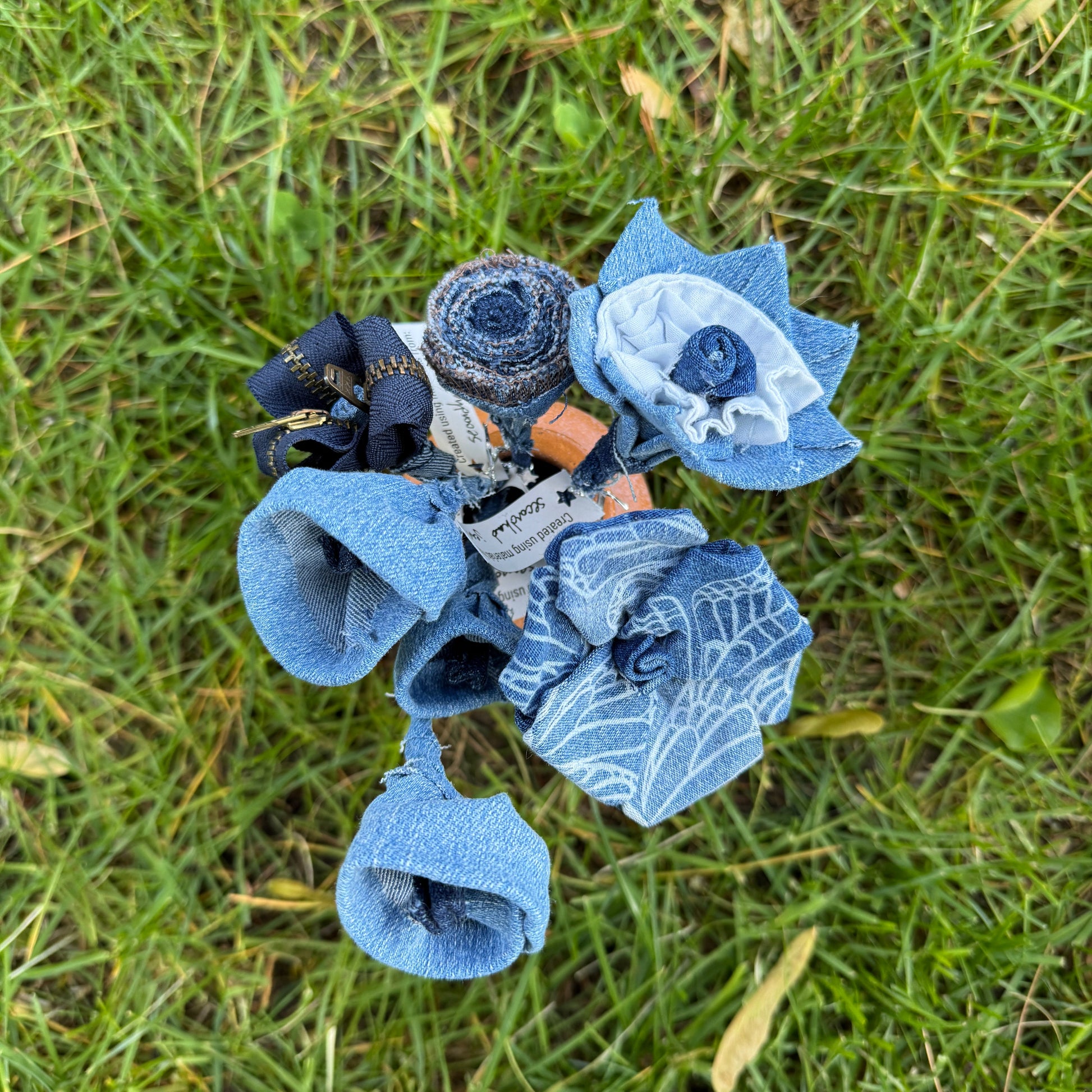 Bouquet of blue fabric flowers on grass