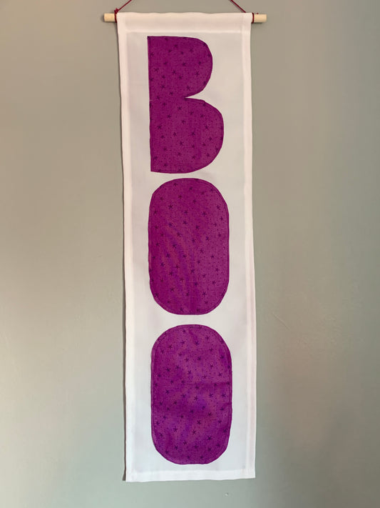 White banner with the word BOO in purple fabric 