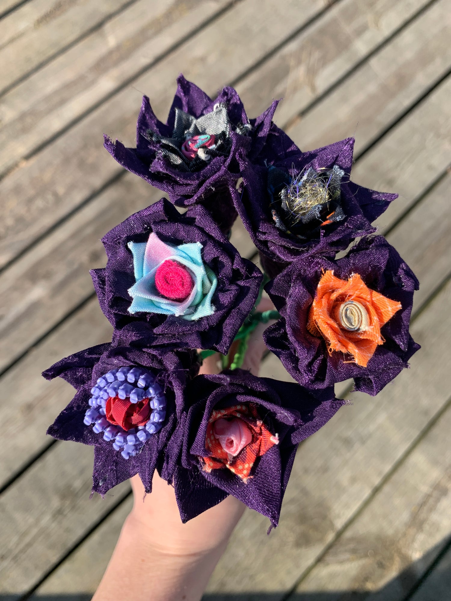 A grouping of purple flowers made from fabric