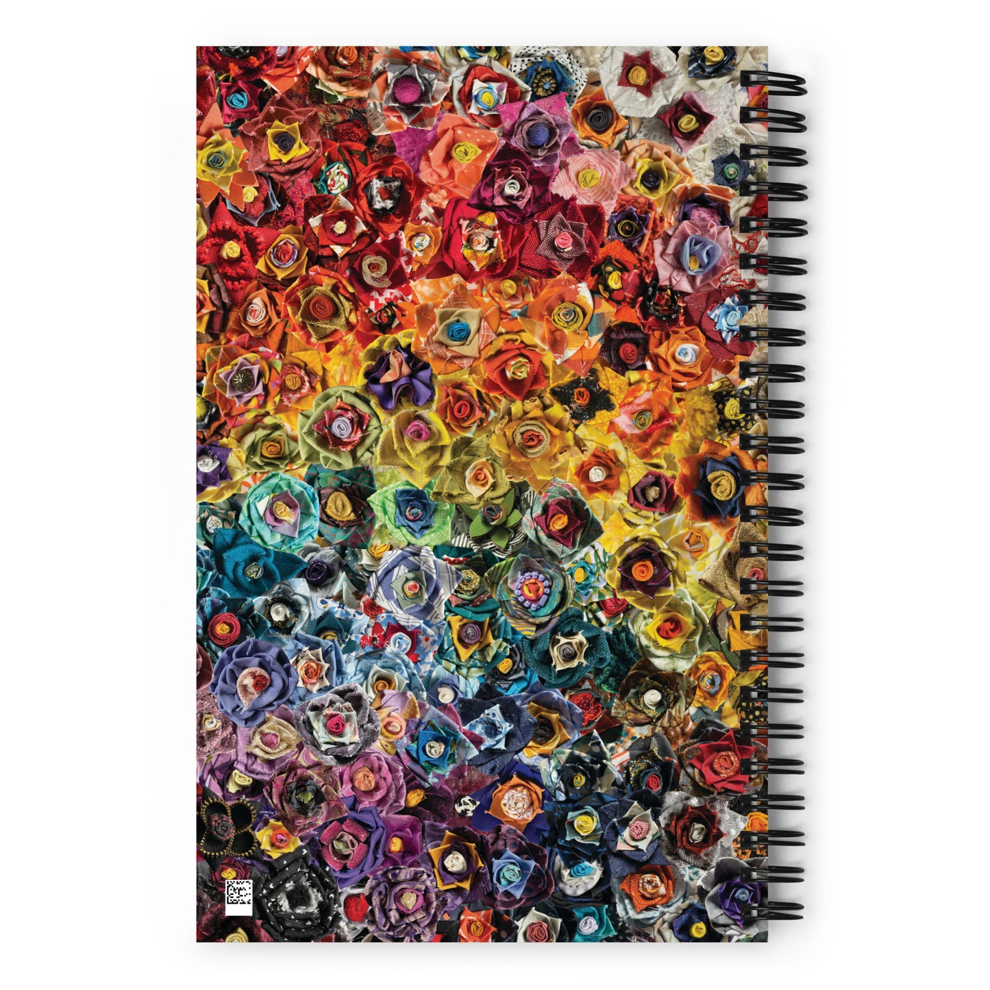 Spiral bound notebook with a rainbow image of fabric flowers