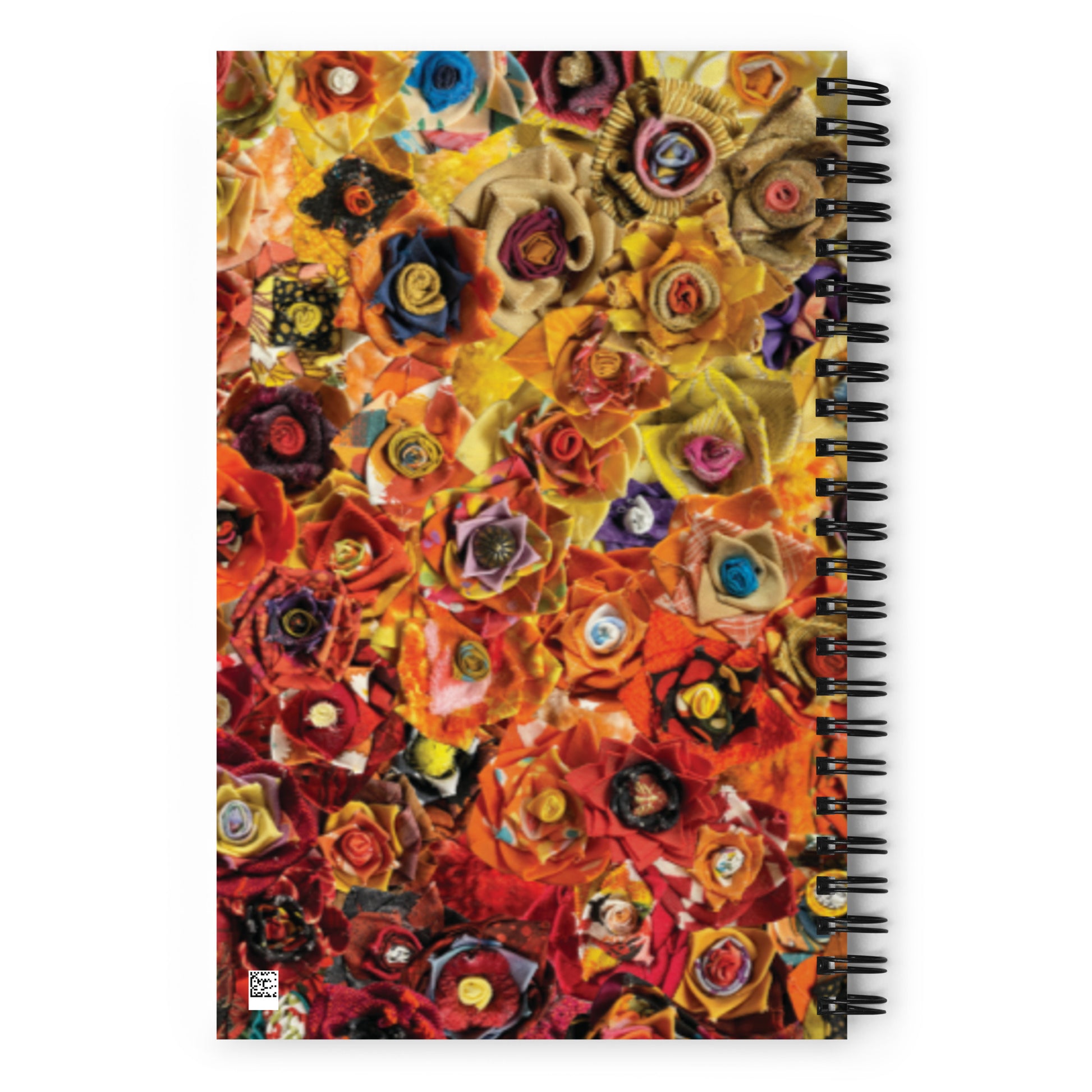 Spiral bound notebook with a red and yellow image of fabric flowers