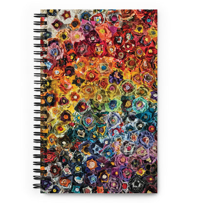 Spiral bound notebook with a rainbow image of fabric flowers