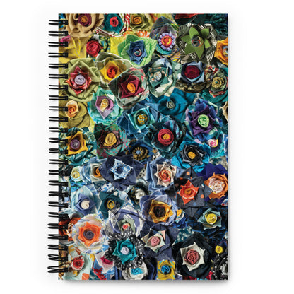 Spiral bound notebook with a blue and green image of fabric flowers