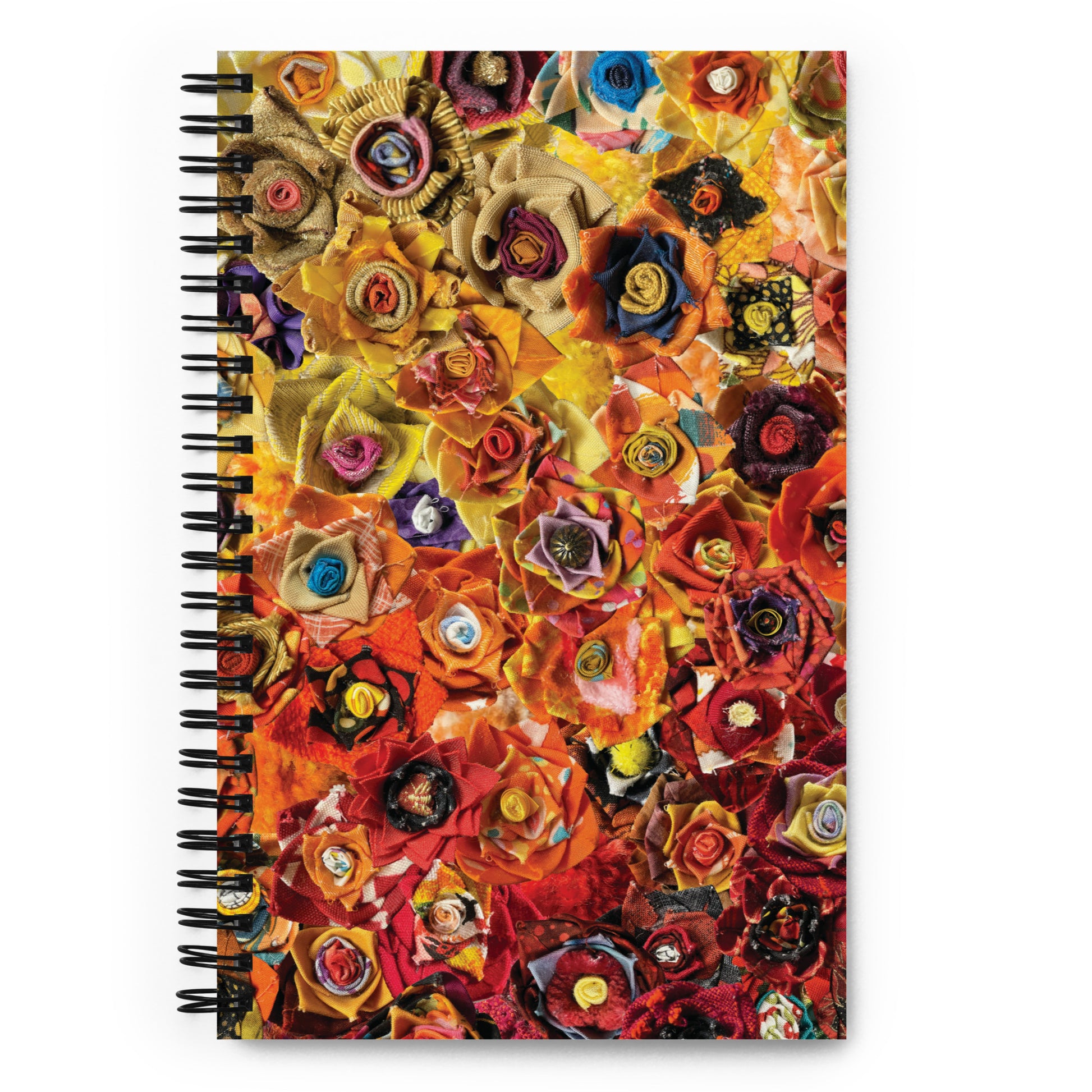 Spiral bound notebook with a red and yellow image of fabric flowers