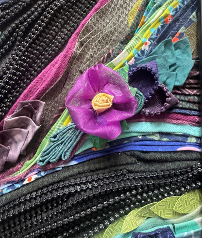 Close-up of a textured background with a purple flower.